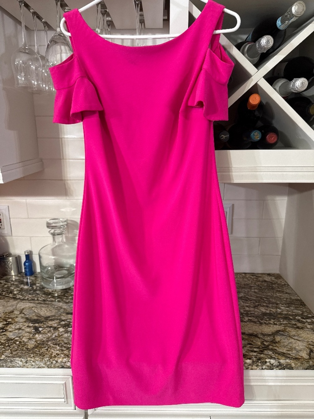 Short, hot pink, open shoulder dress.